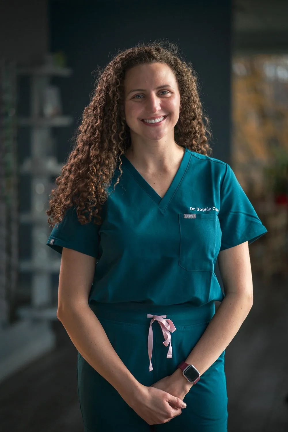 Headshot of a medical professional in scrubs